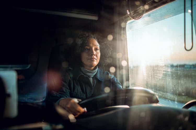 A mature woman driving a truck