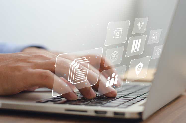 a business man using a computer to manage documents online document communication database and digital file storage systems/software record keeping database technology file