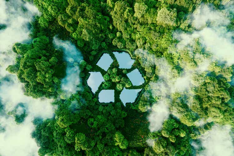 A lake in the shape of a recycled sign amidst unspoiled nature.  An ecological metaphor for ecological waste management and a sustainable and economical lifestyle.  3d rendering.