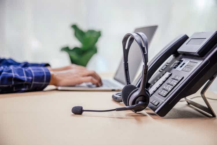 Communication support, call center and customer service help desk. telephone devices with VOIP headset in office.Customer service support (call center) concept.