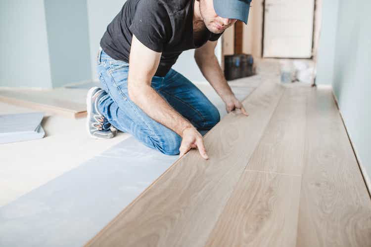 Work of a master floating flooring installation - installing laminate on the floor