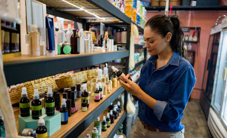 Woman shopping in an organic market and looking at supplements