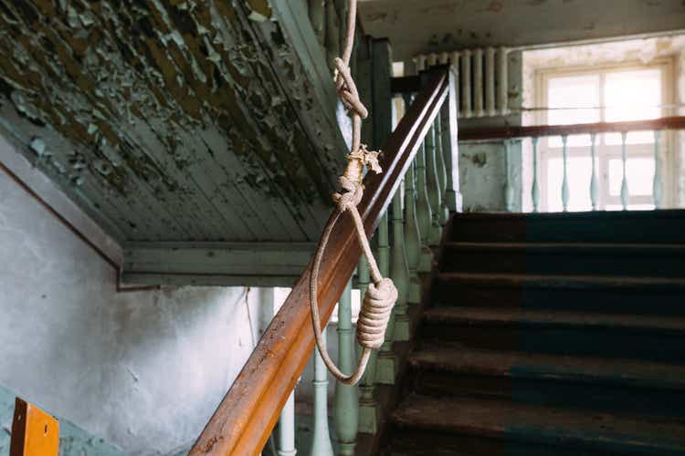 Hanging noose of rope in creepy abandoned building