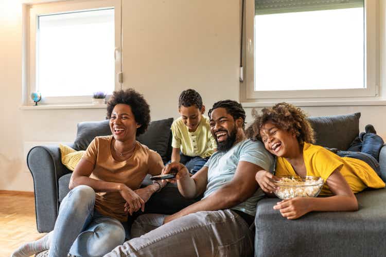 African American family watching a movie at home.