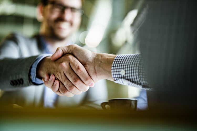 Close up of businessmen came to an agreement in the office.