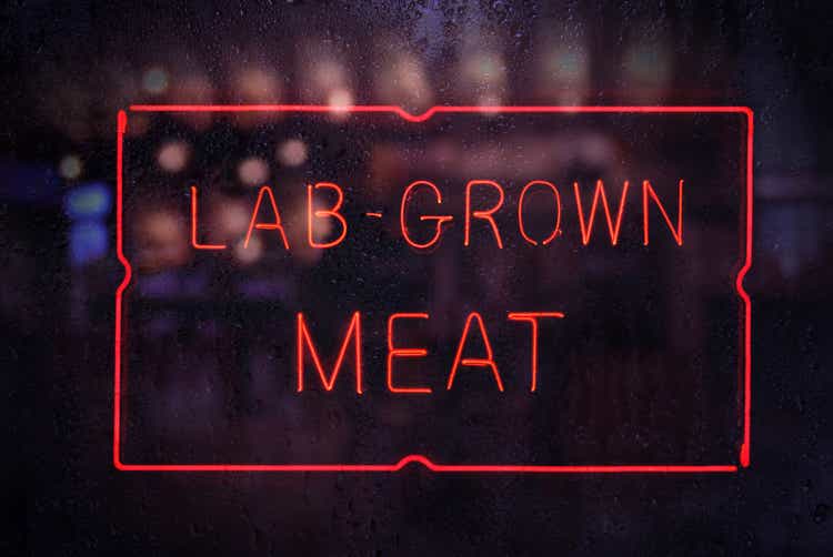 Lab-Grown Meat Sign in Rainy Shop Window