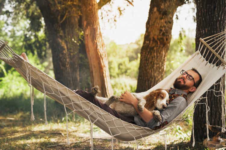 Resting with dog in a hammock outdoors