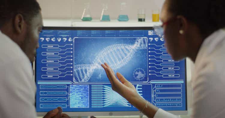 African ethnicity scientists studying DNA samples. Computer screens with DNA sequences. Discussing