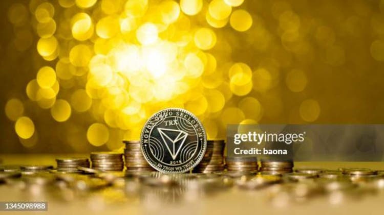 Heap of TRON coins on shiny golden background