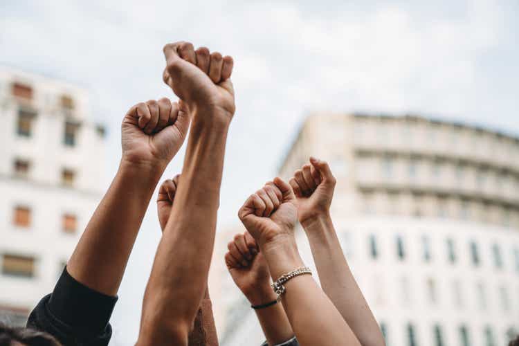 People with raised fists at a demonstration in the city