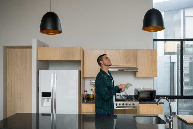 Man controlling the lights of his house using a home automation system