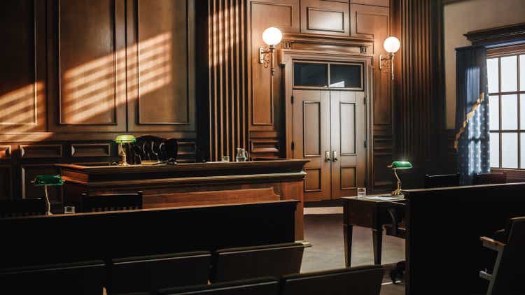 Empty American Style Courtroom. Supreme Court of Law and Justice Trial Stand. Courthouse Before Civil Case Hearing Starts. Grand Wooden Interior with Judge"s Bench, Defendant"s and Plaintiff"s Tables.