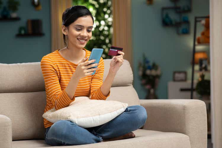 Happy woman shopping online at home stock photo