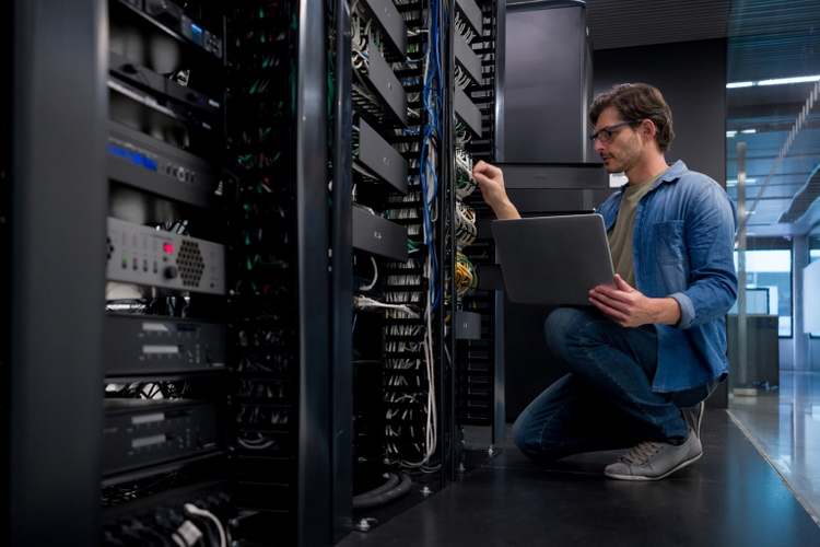 IT support technician fixing a network server at an office