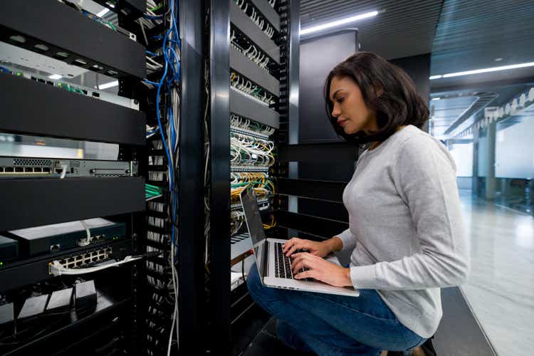 IT support technician fixing a network server at an office
