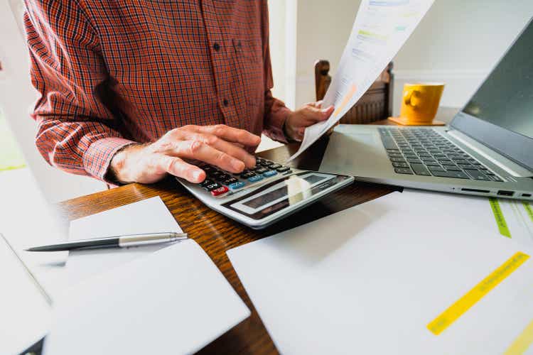 Senior man checking bills at home