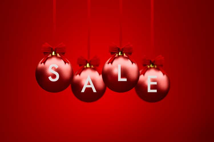 Sale Written Over Red Christmas Baubles Hanging Over Red Background