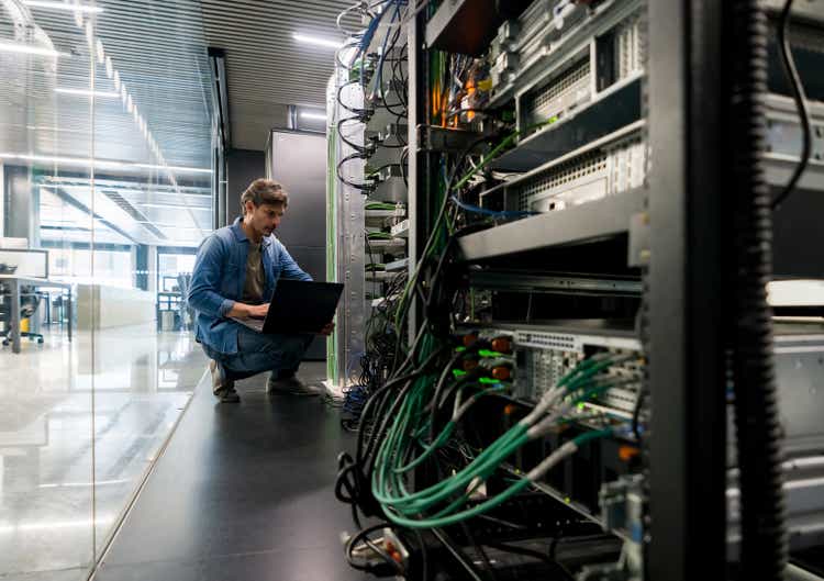 Computer technician fixing a network server at the office