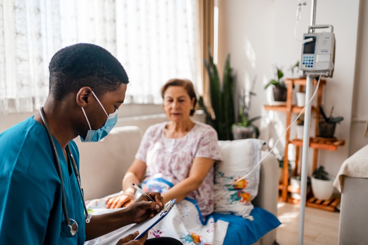 Health visitor and senior woman during home visit