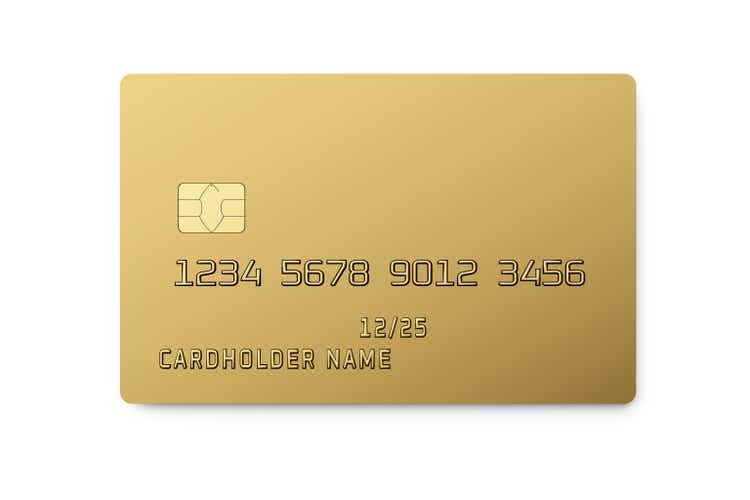 Golden plastic card with chip isolated on white. Payment or credi