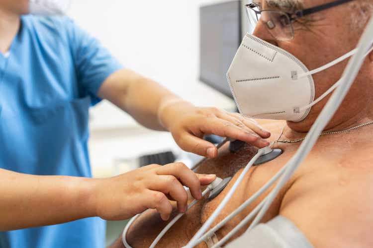 Senior man having electrocardiogram test in clinic