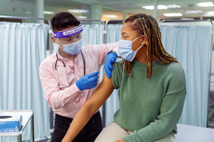 Black woman receiving COVID-19 vaccination injection