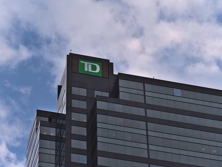 Low angle view of the top of high-rise office building TD Canada Trust Tower in Calgary downtown with logo of the company and cloudy sky in the evening.