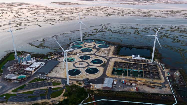 Sustainable energy is used in environmental conservancy. A wastewater treatment plant powered by wind turbines and solar panels near Atlantic City in New Jersey, USA.