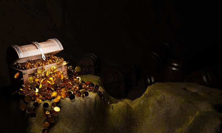 Golden Coins and vintage treasure chest made of wooden panels Reinforced with gold metal and gold pins Treasure boxes placed on the sand in a cave or treasure chest underwater. 3d Rendering