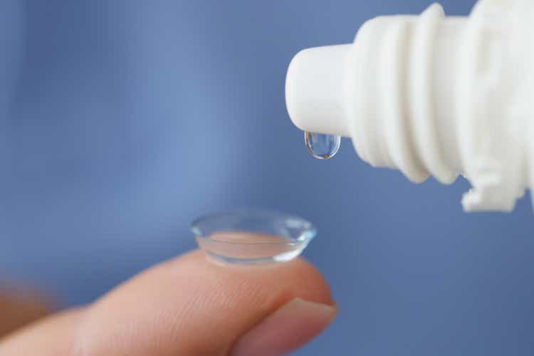 Solution is dripped onto soft contact lens closeup