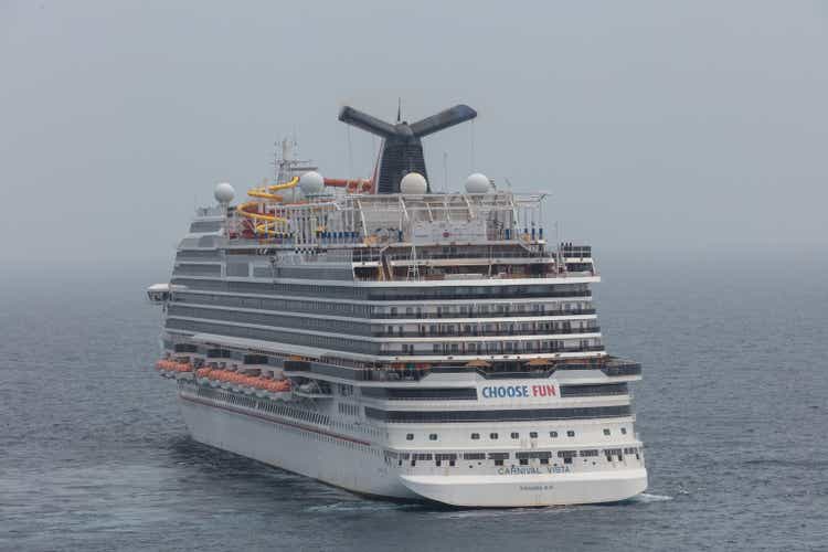 Aerial cloe-up shot of Carnival Vista anchored at sea in the fog. Grey foggy sky in the background
