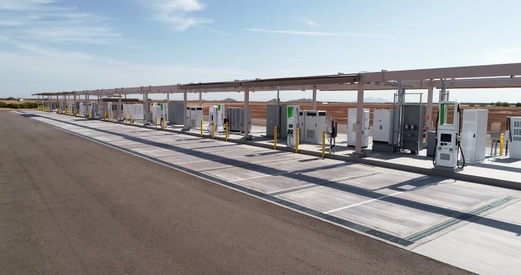 Aerial view of a large electric charging station with an empty parking lot for electric cars.