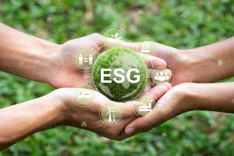 ESG Environmental, social, and corporate governance concept.Hands holding the green ball that writes the word ESG and ESG icon concept, Nature onservation, Ecology, Social Responsibility, and Sustainability.