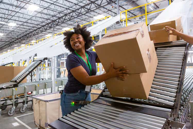 Cheerful Warehouse Employee Loading Boxes Into Truck