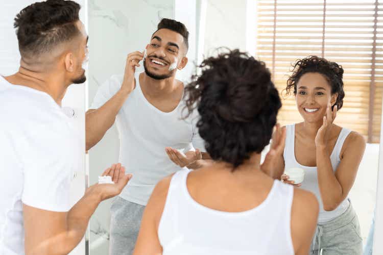 Morning Routine. Happy Arab Couple Getting Ready Together Near Mirror In Bathroom