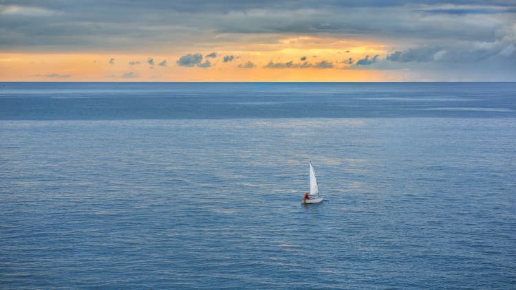 sailing ship in the sea against the blue sky.