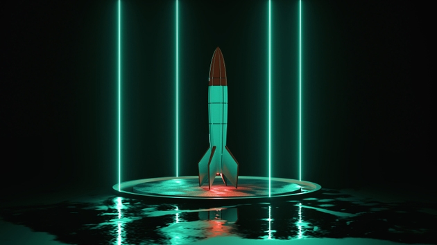 Rocket on a platform with glowing neons . Future innovation start up concept .