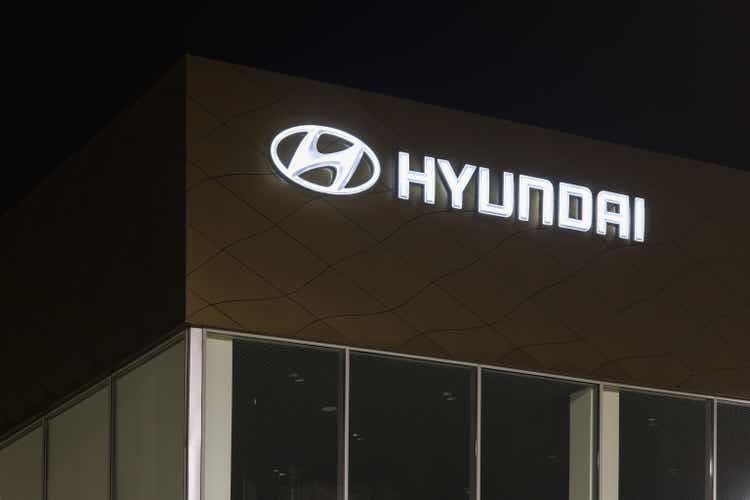 Hyundai logo on car dealership building at night - Hyundai is a South Korean multinational car manufacturer