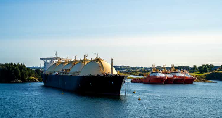 Fjord landscape with LNG tanker and tug ships in Norway