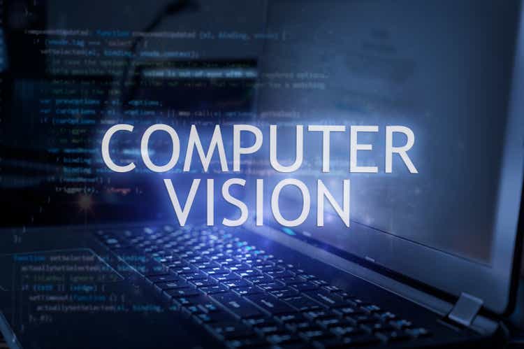 Computer vision inscription against laptop and code background.