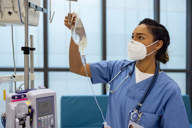 Nurse at the hospital putting an IV Drip on a patient