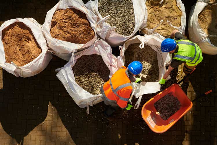 workmen shovelling aggregates