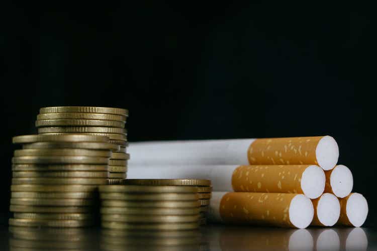 Cigarettes.Tobacco Cigarettes and money coins.Cigarettes and TAX concept. Smoking is a waste of money.