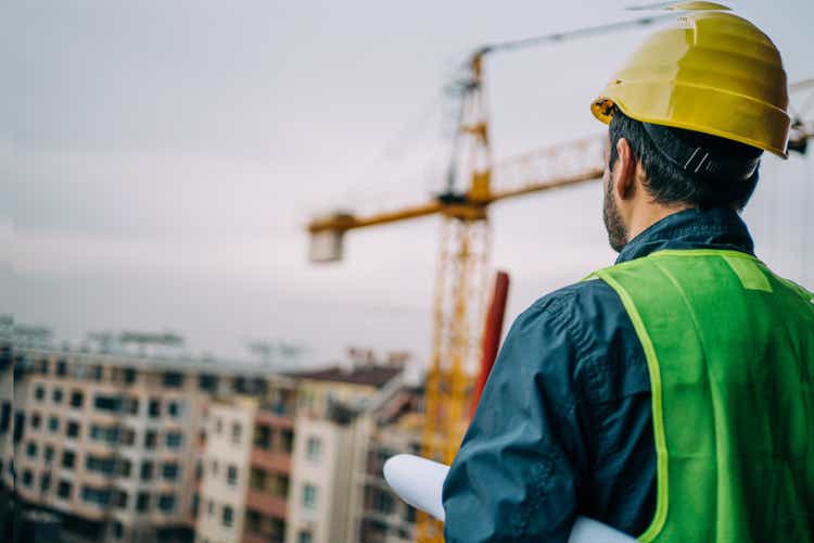 Construction engineer supervising building process.