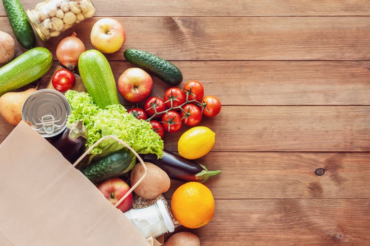 Paper shopping food bag with grocery and vegetables