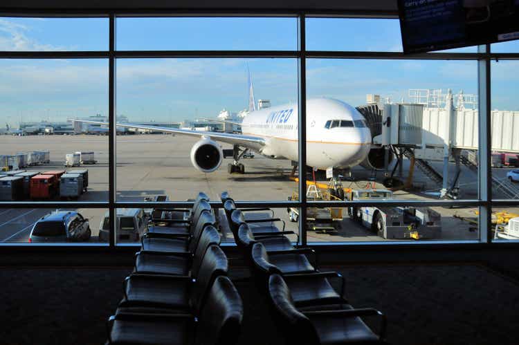 United Airlines Boeing 777 jet seen from a gate waiting lounge at Denver International Airport, Denver, Colorado, USA
