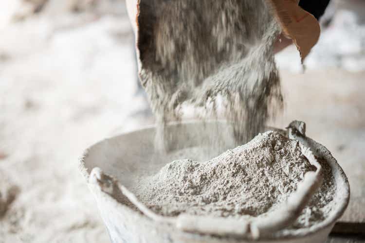 Filling a bucket with cement at construstion site