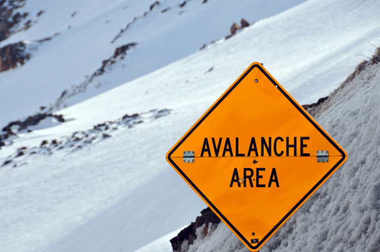 Avalanche sign against snow covered slope