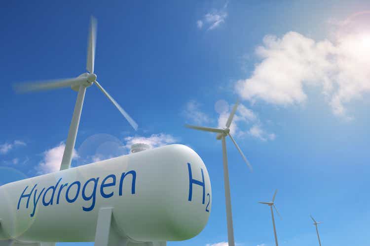 Hydrogen tank and windmills on blue sky background. Sustainable and ecological energy concept. 3d illustration.