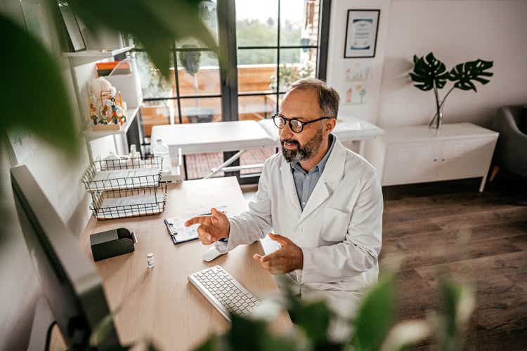 Doctor explaining his patient how to use prescribed medicine